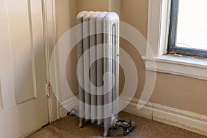 Vintage Radiator Beside a Window in an Old American Apartment Building