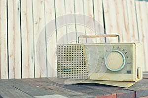 Vintage radio on an old wooden background