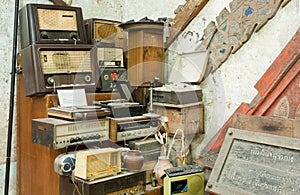 Vintage radio receptor and some other antiques and old electronic devices inside antique shop