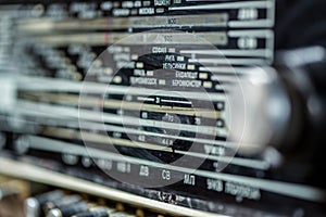 Vintage radio tuning knob close-up . names of cities in the world in Russian . blurred background. small focusing area, selective