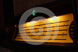 Vintage radiogram scale illuminated with yellow light photo