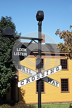 Vintage Railroad Crossing sign with building in background