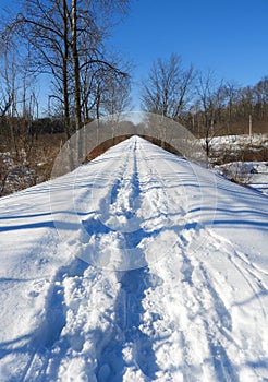 Vintage railroad track repurposed hiking path in winter