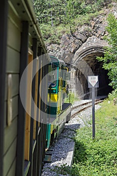 Vintage Railroad Train Enters a Dark Tunnel