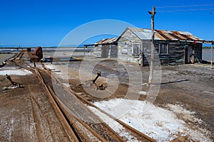 Vintage railway. Old rails at a salt factory. Wooden warehouses. Sea salt