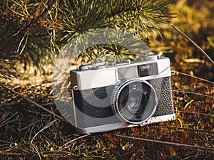 A vintage rangefinder film camera in natural outdoor