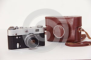 Vintage rarity film photo camera and leather storage case on a white background.