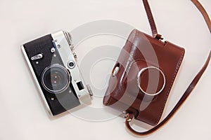 Vintage rarity film photo camera and leather storage case on a white background.