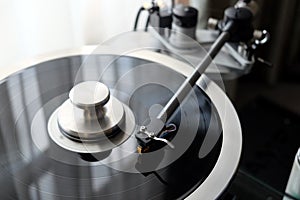 Vintage record player with graphite tonearm closeup view