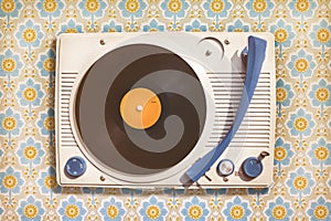 Vintage record player on top of flower wallpaper photo