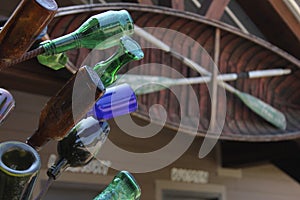 Vintage Recycled Bottles on Metal Rack With American Flag in Background