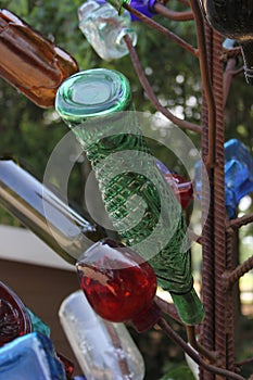 Vintage Recycled Bottles on Metal Rack in Outdoor Park