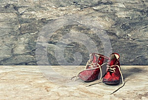 Vintage red baby shoes. retro style toned picture