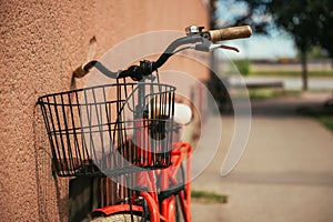 Vintage red bicycle on the street leaning on to building wall