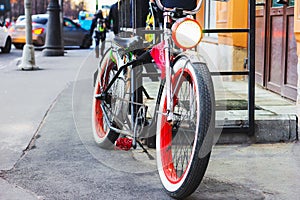 Vintage red bike parked on the street