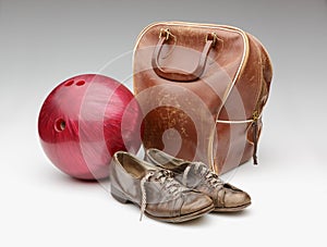 Vintage Red Bowling Ball, Distressed Leather Bag and Brown Shoes