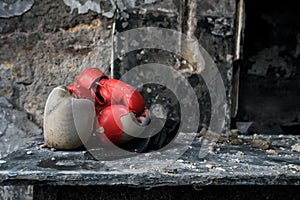 Vintage red Boxing gloves on old table in burnt room