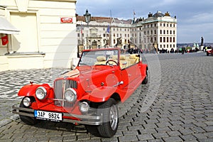Vintage red car in front of Prague castle