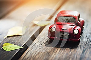 Vintage Red Classic Car Parking on Wood Floor with Autumn Sunlight