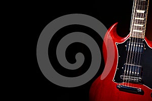 Vintage red electric guitar on moody dark background