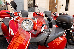 Vintage red Italian moto on traditional street. A motor scooter on the sidewalk in the old town of Rome