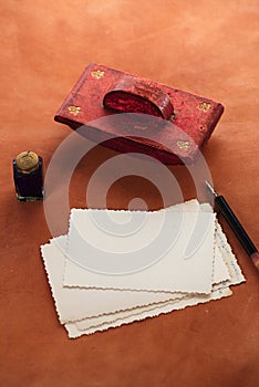 Vintage red leather ink blotter with retro post cards on leathe