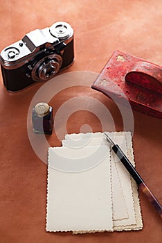 Vintage red leather ink blotter with retro post cards on leathe