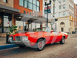 A vintage red Oldsmobile 442, in downtown Flint, Michigan