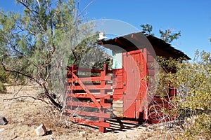 Vintage Red Outhouse in The Desert