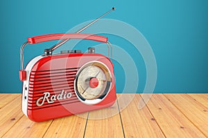 Vintage red radio receiver on wood table.