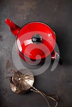 Vintage red teapot and mesh strainers