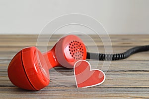 Vintage red telephone handset and heart shaped tag