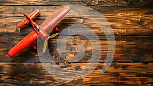 Vintage red toy airplane on wooden background