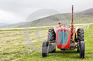 Vintage red tractor in a field in UK