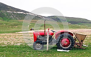 Vintage red tractor in a field in UK