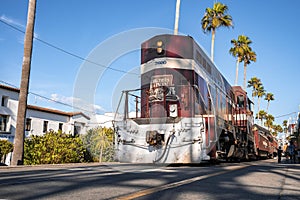 Vintage red tram with text moving at Santa Cruz Beach Boardwalk