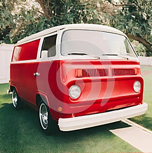 Vintage red van in the yard.