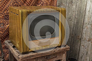 Vintage, Retro, Ancient old tv wooden cabinet stands on the floor with wooden and retro background.