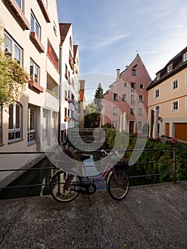 Vintage retro bike bicycle used as decoration with flowers in basket in historic charming old town of Ulm city Germany