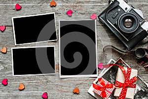 Vintage retro camera on wood table background with blanks photos