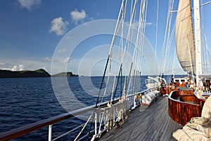 Vintage retro classic old sailboat sailing on dark blue ocean.