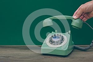 A vintage or retro green british telephone