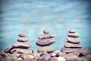 Vintage retro hipster style image of stones on beach.