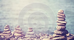 Vintage retro hipster style image of stones on beach.