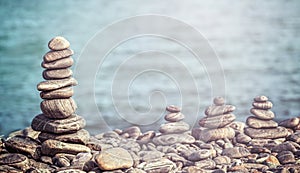 Vintage retro hipster style image of stones on beach.