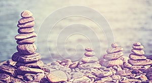 Vintage retro hipster style image of stones on beach.