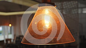 Vintage Retro Lamp Lighting Decoration in Loft Style. Old School Light Hanging on Ceiling in Coffee Shop. 4K.