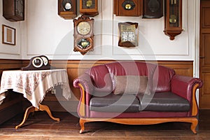 vintage retro room with leather sofa and clocks on the wall