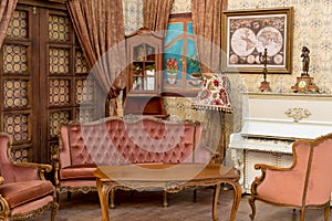 Vintage retro room setting with sofa, accessories, old rusty white piano. Ideal for postcard