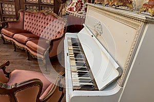 Vintage retro room setting with sofa, accessories, old rusty white piano. Ideal for postcard